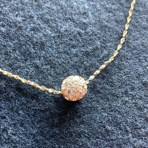 This Lia Sophia necklace is gold and 8 inches long.